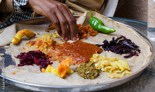 Traditional vegetarian Ethiopian food on a silver  plate © kubikactive