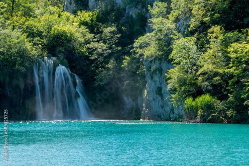 One of the many waterfalls in Plitivice Lakes National Park in Croatia  cascading into the turquoise blue waters of a lake below