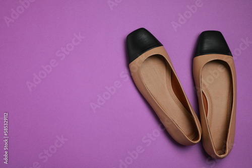 Pair of new stylish square toe ballet flats on purple background, flat lay. Space for text