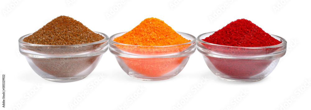 Glass bowls with different food coloring isolated on white