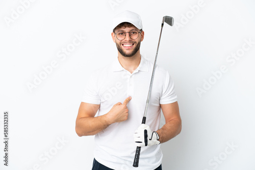 Handsome young man playing golf isolated on white background with surprise facial expression