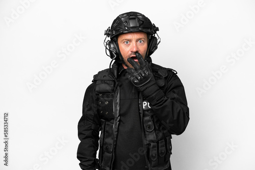 Middle age SWAT man isolated on white background surprised and shocked while looking right © luismolinero