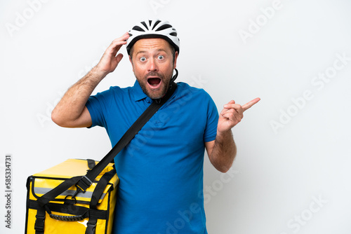 Middle age caucasian man with thermal backpack isolated on white background surprised and pointing finger to the side