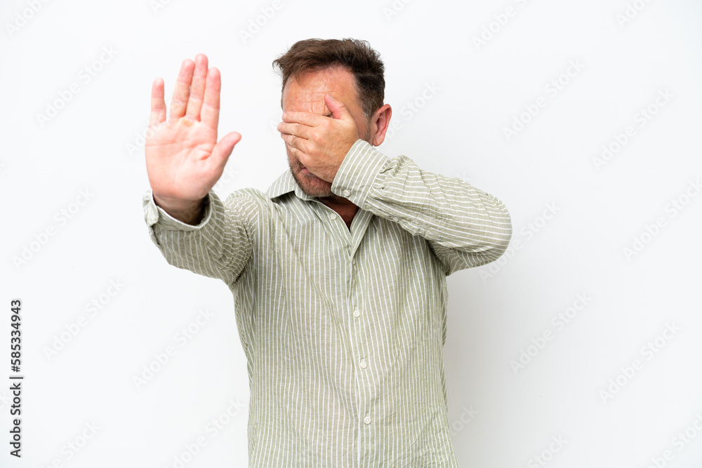 Middle age caucasian man isolated on white background making stop gesture and covering face Middle age caucasian man isolated on white background making stop gesture and covering face