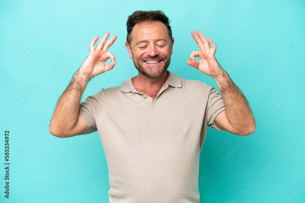 Middle age caucasian man isolated on blue background in zen pose Middle age caucasian man isolated on blue background in zen pose
