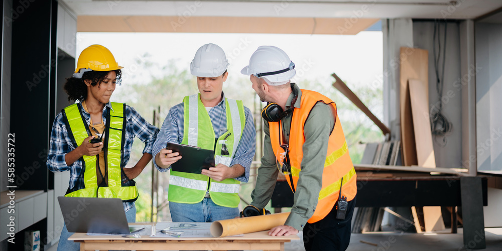 Engineers are discussing data working and laptop or tablet with architectural project at new construction site on big project.. Engineers are discussing data working and laptop or tablet with architectural project at new construction site on big project..