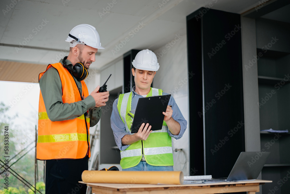 Architect caucasian man working with colleagues mixed race in the construction site. Architecture engineering on big project. Building in construction interior. Architect caucasian man working with colleagues mixed race in the construction site. Architecture engineering on big project. Building in construction interior.