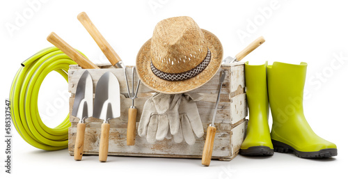 Fototapeta Naklejka Na Ścianę i Meble -  Gardening tools set, wooden crate with garden kit, rubber green boots, hose, handle trowel, straw hat and protective gloves, isolated on white background. Concept of work or sale garden products