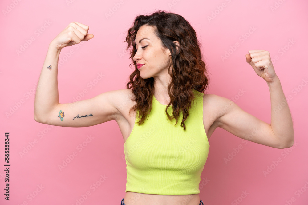 Young caucasian woman isolated on pink background doing strong gesture Young caucasian woman isolated on pink background doing strong gesture
