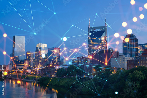 Panoramic view of Broadway district of Nashville over Cumberland River at illuminated night skyline, Tennessee, USA. Social media icons. The concept of networking and establishing people connections