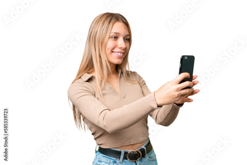 Young pretty blonde woman over isolated chroma key background making a selfie