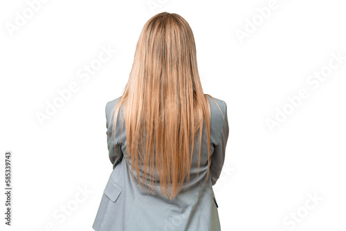 Young pretty blonde woman over isolated chroma key background in back position