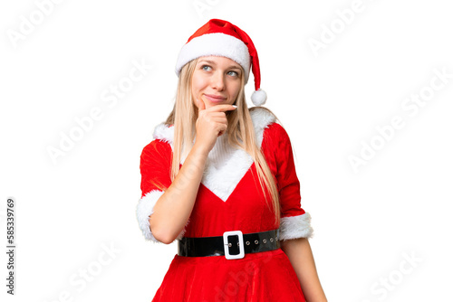 Young blonde woman with christmas hat over isolated chroma key background having doubts