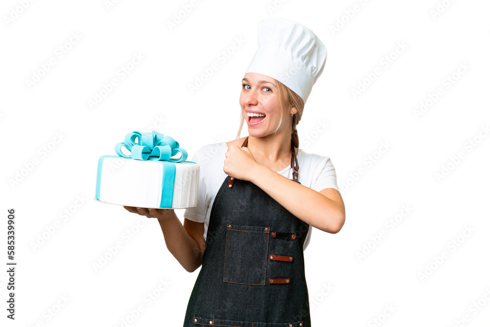 Young pastry blonde woman with a big cake over isolated chroma key background celebrating a victory Young pastry blonde woman with a big cake over isolated chroma key background celebrating a victory