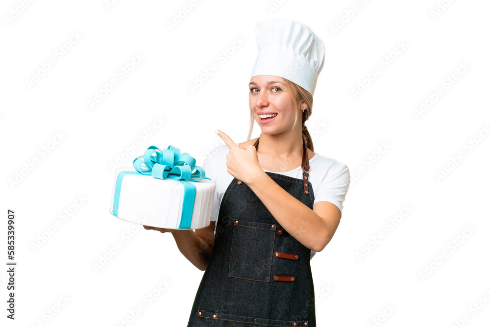 Young pastry blonde woman with a big cake over isolated chroma key background pointing back Young pastry blonde woman with a big cake over isolated chroma key background pointing back