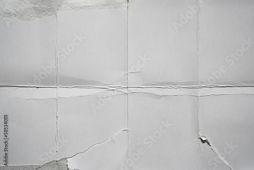 White damaged paper background folded into eight parts