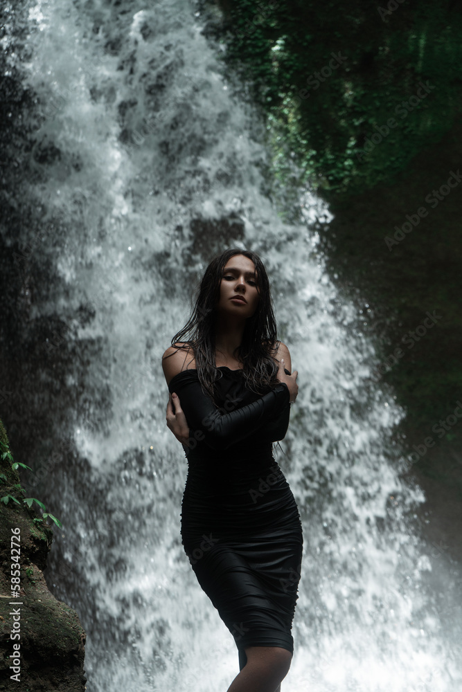 Young sexy woman posing at the waterfall in jungles. Ecotourism concept image travel girl Young sexy woman posing at the waterfall in jungles. Ecotourism concept image travel girl