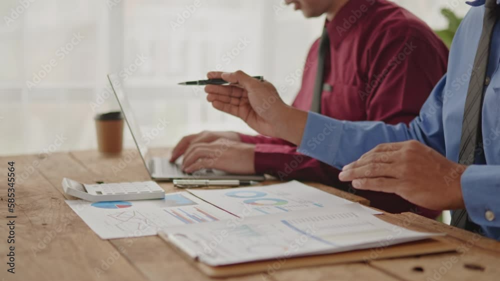 Businessman teamwork are working and brainstorming calculate on paperworks and laptop that shows chat and graph of of accounting static financial cost and marketing. Businessman teamwork are working and brainstorming calculate on paperworks and laptop that shows chat and graph of of accounting static financial cost and marketing.