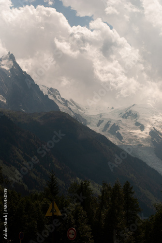 View on white clouds over mountains in Alps in sunny day