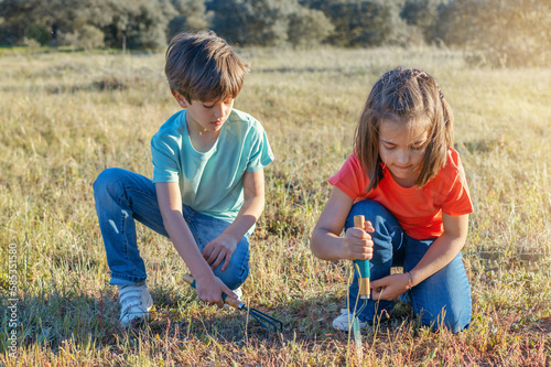 Little Children Playing Outdoors With Garden Objects. Outdoor Activities In Summer Camps For Children