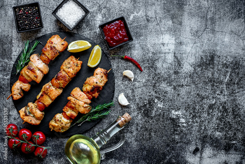 salmon kebab on skewers,grilled on a stone background with copy space for your text