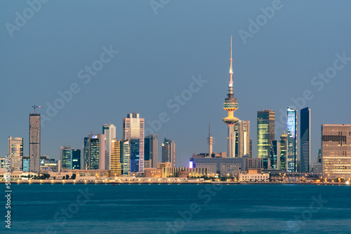 Panoramic view of Kuwait City glowing skyline at night