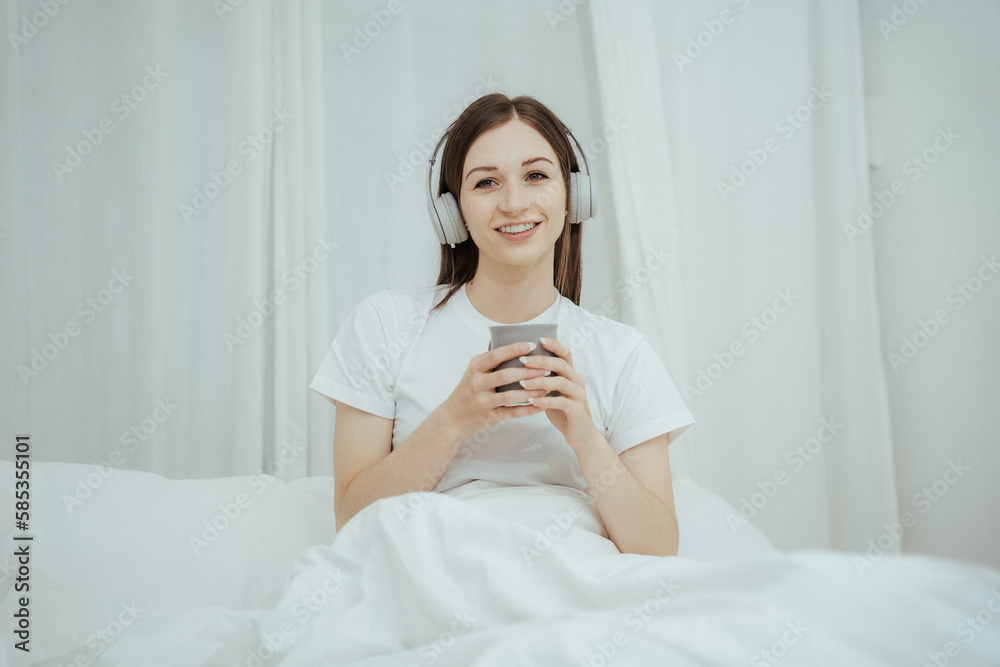 Beautiful girl at her bedroom drinking tea in the morning. Beautiful girl at her bedroom drinking tea in the morning.