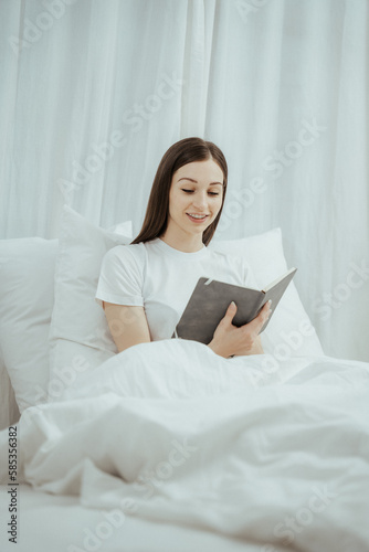 Happy woman holding apple and listening to music sitting on sofa in living room at home