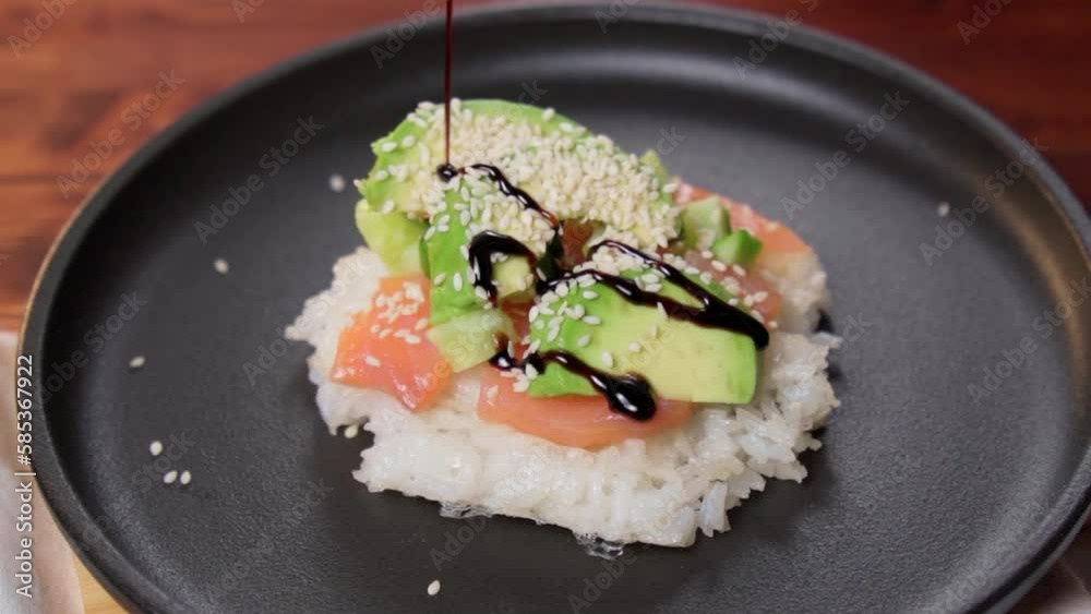 Sushi waffles are crispy rice cooked in a waffle iron, with salmon crunchy cucumber, and avocado. Slow motion Sushi waffles are crispy rice cooked in a waffle iron, with salmon crunchy cucumber, and avocado. Slow motion