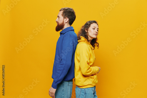 Man and woman couple smiling cheerfully and crooked with glasses, on yellow background, symbols signs and hand gestures, family shoot, newlyweds. © SHOTPRIME STUDIO