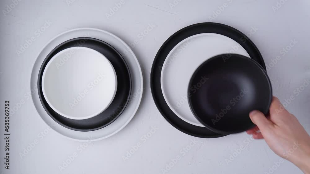 White and black food is an empty ceramic dish on a concrete background. Top View White and black food is an empty ceramic dish on a concrete background. Top View