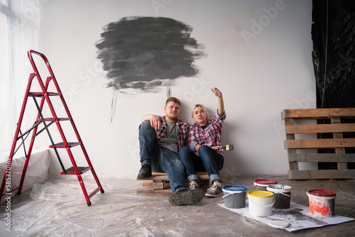 Принти на полотні Young happy family married couple renovating house and planning a design project