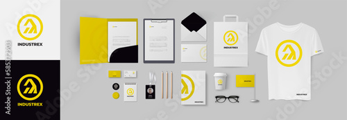 Industrial yellow logo and corporate identity set in minimal style with folder, business card and envelope. Corporate branding design bundle for build or technical company.