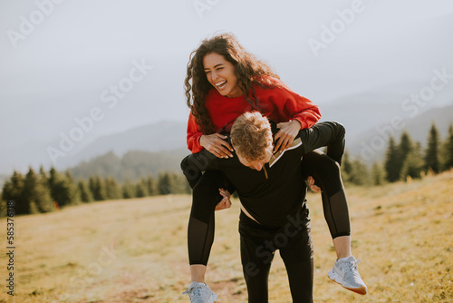 Young woman riding piggybac...