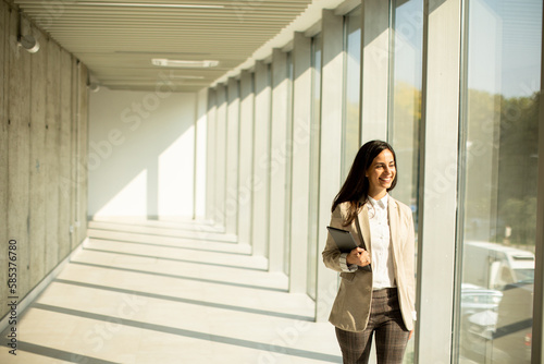 Young businesswoman walking...