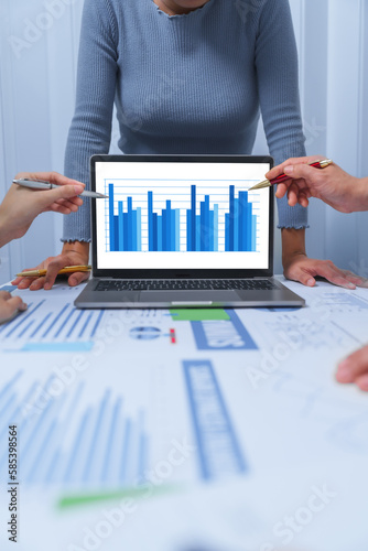 Fotografie small business accounting team meeting three asian people with salary monthly charts data, basic business accounting and bookkeeping concept