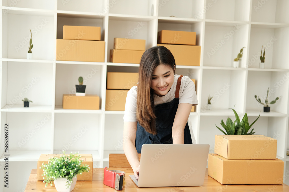 Startup small business SME, Entrepreneur owner using smartphone or tablet taking receive and checking online purchase shopping order to preparing pack product box. Selling online ideas concept Startup small business SME, Entrepreneur owner using smartphone or tablet taking receive and checking online purchase shopping order to preparing pack product box. Selling online ideas concept