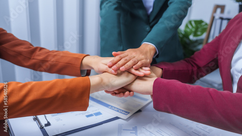 join hands teamwork concept. small business accounting team meeting three asian people with salary monthly charts data, basic business accounting and bookkeeping concept.