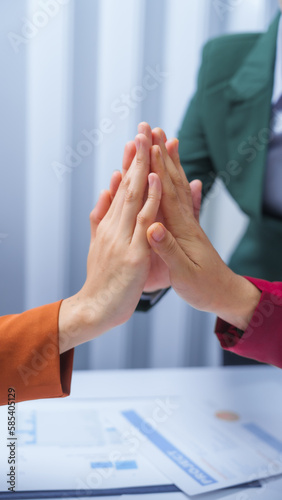 join hands teamwork concept. small business accounting team meeting three asian people with salary monthly charts data, basic business accounting and bookkeeping concept.