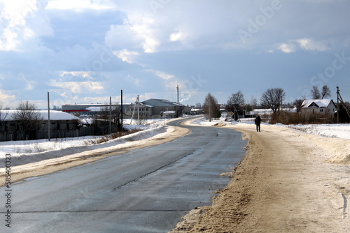 Highway passing through the village in early spring on a sunny day. photo