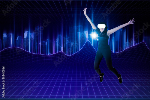 Happy young wearing VR headset jumping