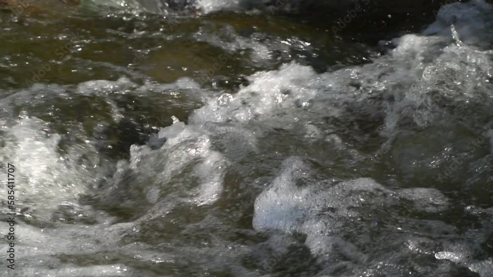 Water flow with river rapids and stone, slow motion Water flow with river rapids and stone, slow motion