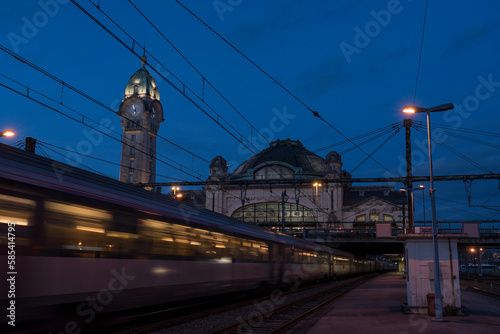 Train driving past Gare des Benedictins at dusk, Limoges, Winter, France