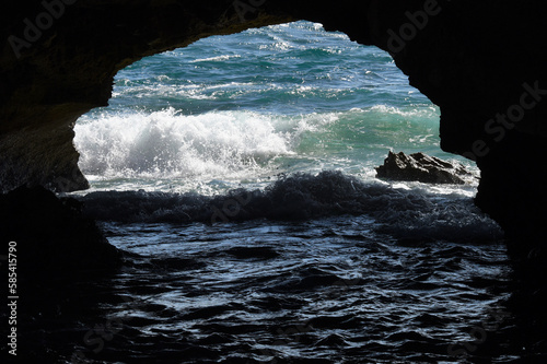 Ocean waves striking a sea cave