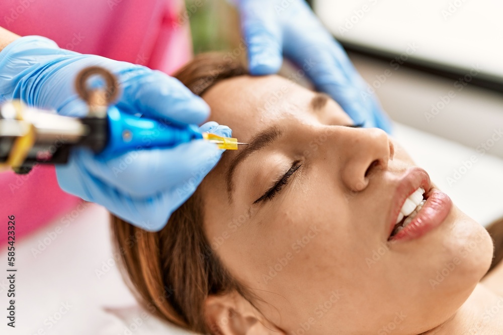 Young latin woman having mircoblading treatment Young latin woman having mircoblading treatment