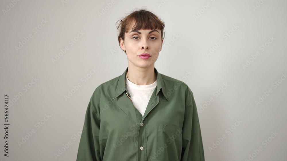 Young caucasian woman standing with serious expression over isolated white background Young caucasian woman standing with serious expression over isolated white background