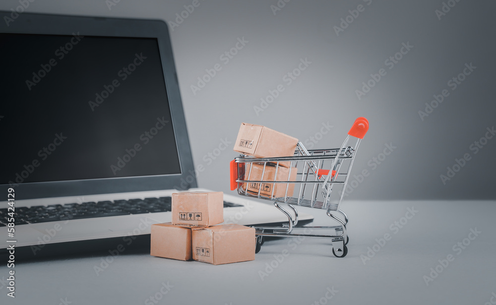 Online shopping, home delivery. Brown paper boxes in a shopping cart