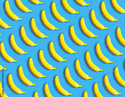 Beautiful fresh bananas lie on a blue background, pattern. Vitamins and fruits, creative idea