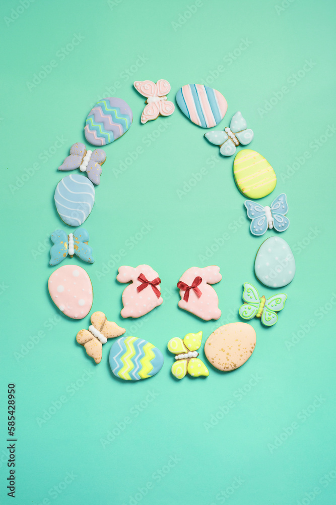Vertical Easter banner on a mint background. Homemade gingerbread cookies. Easter eggs and cookies in the shape of a rabbit and a butterfly. Easter concept.