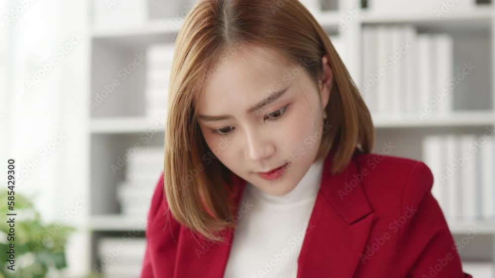 Businesswoman seriously stressed working and headached due to office syndrome on laptop and paperwork in the office. Businesswoman seriously stressed working and headached due to office syndrome on laptop and paperwork in the office.